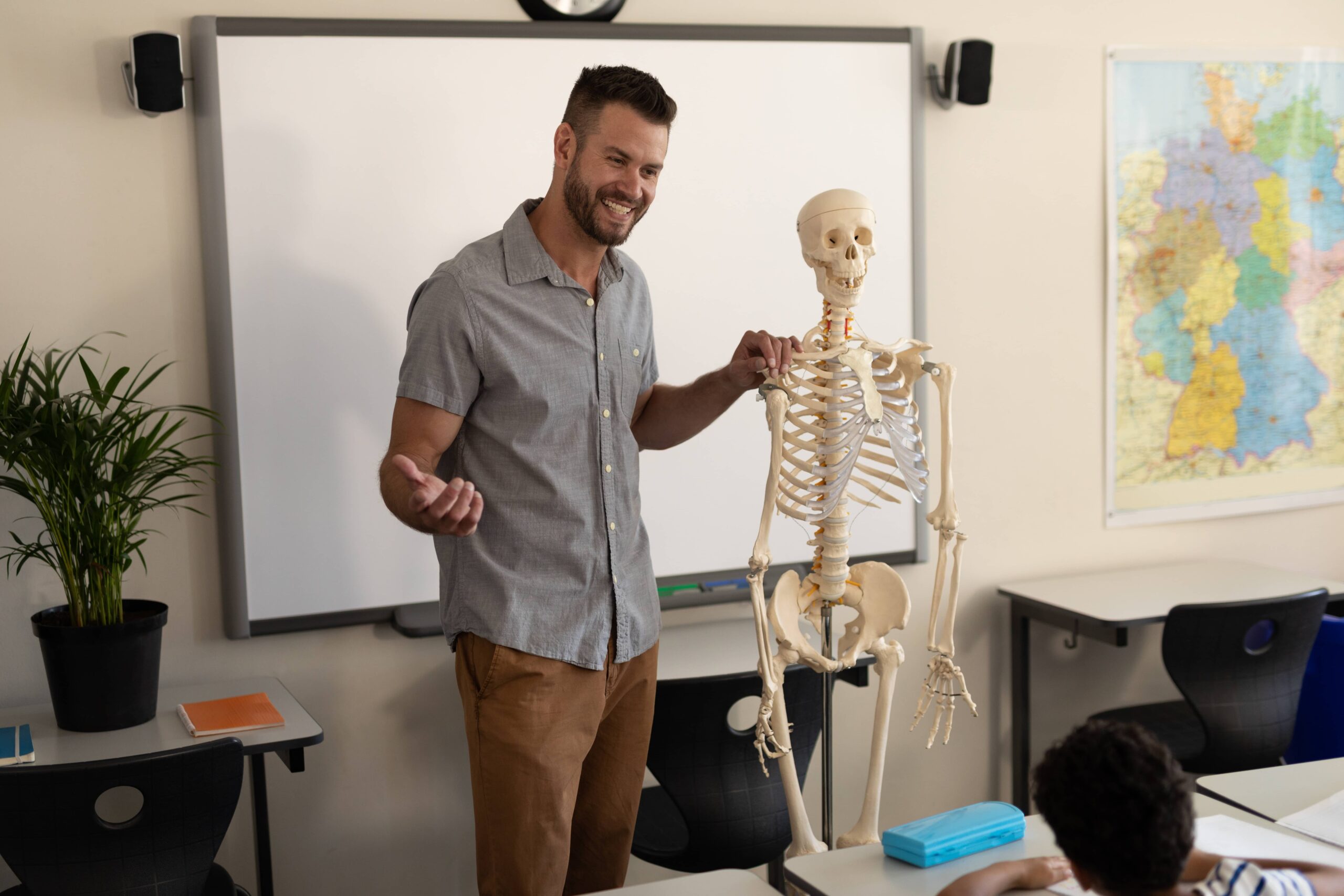 teacher presenting skeleton during class